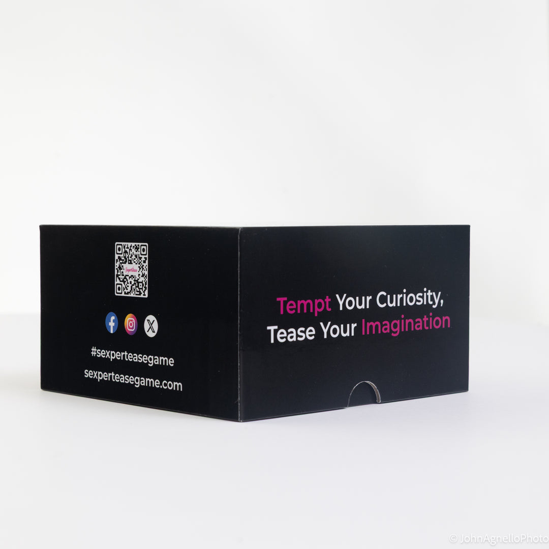 A black rectangular product box with printed text and social media icons, photographed on a clean white studio background. The box reads &